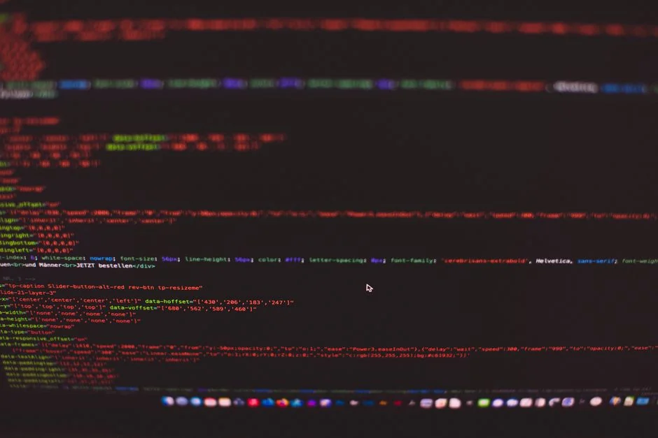 Dual monitors on a desk, showcasing web design in a modern office setting.